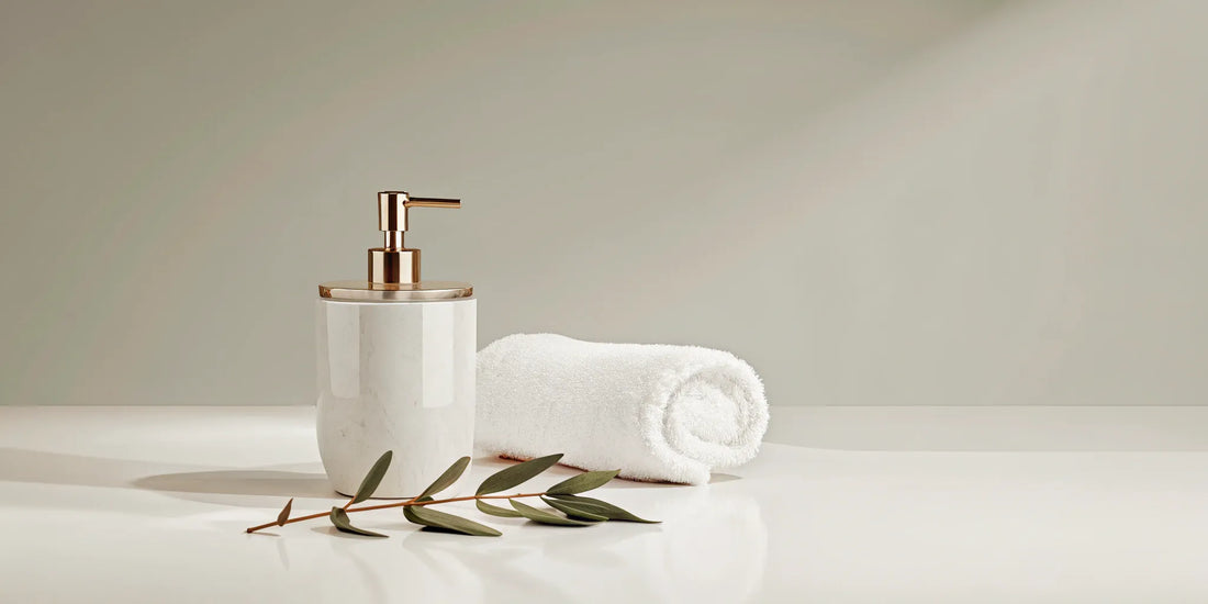 A minimalist white dispenser of affordable Aesop dupe hand soap next to a towel.