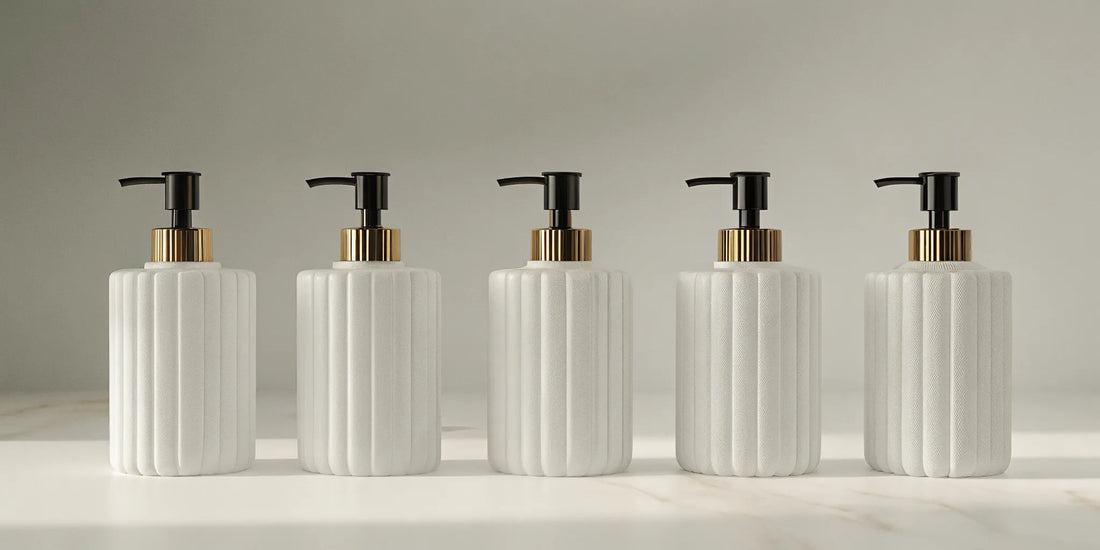 Five modern bathroom hand soap dispensers with black pumps and gold accents.