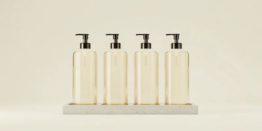 Best glass soap dispensers with black pumps on a tray for a stylish sink.