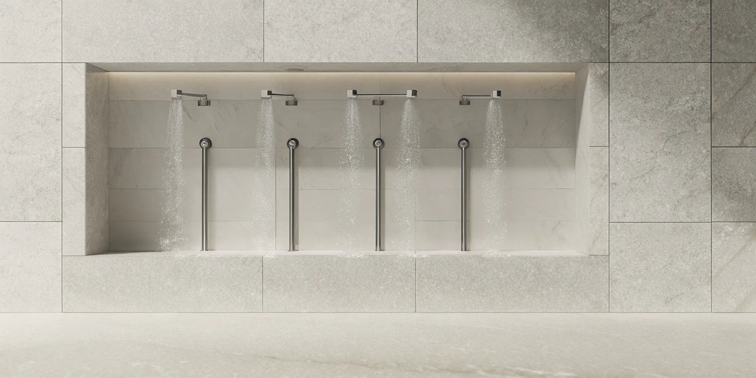 Wall-mounted shower bottle dispensers in a modern, tidy shower.