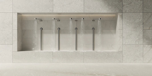 Wall-mounted shower bottle dispensers in a modern, tidy shower.