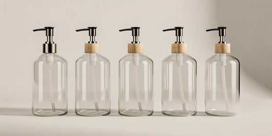 Stylish glass soap refill containers with pumps for an eco-friendly home.
