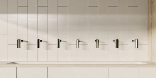 Modern wall mounted kitchen dispensers with a minimalist design on a tiled wall.