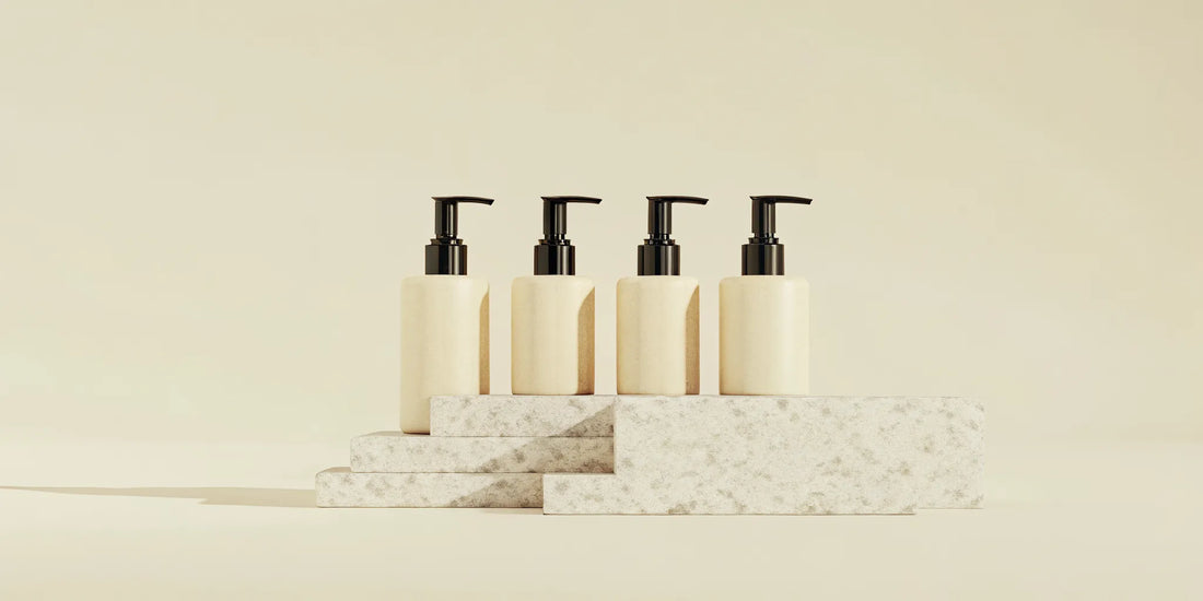 Four minimalist pump soap bottles on stone blocks, an alternative to Aesop Reverence.