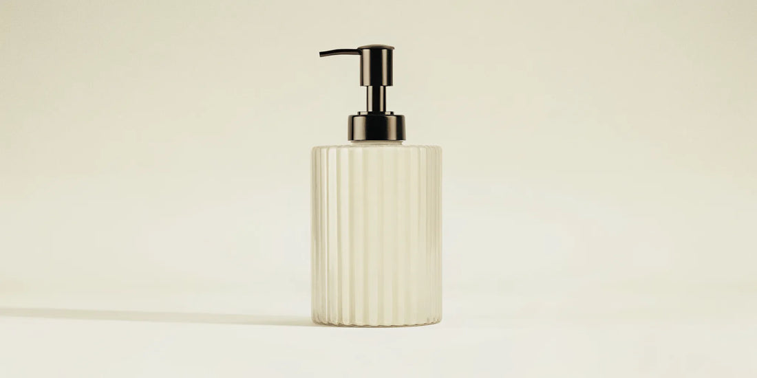 Best countertop soap dispenser featuring a ribbed glass design and a sleek black pump.