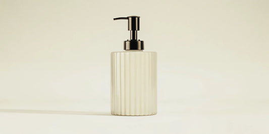 Best countertop soap dispenser featuring a ribbed glass design and a sleek black pump.