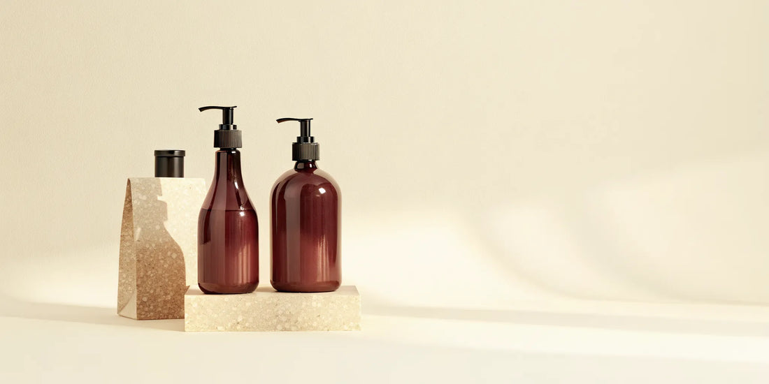 Designer hand soap dispensers on a polished stone counter