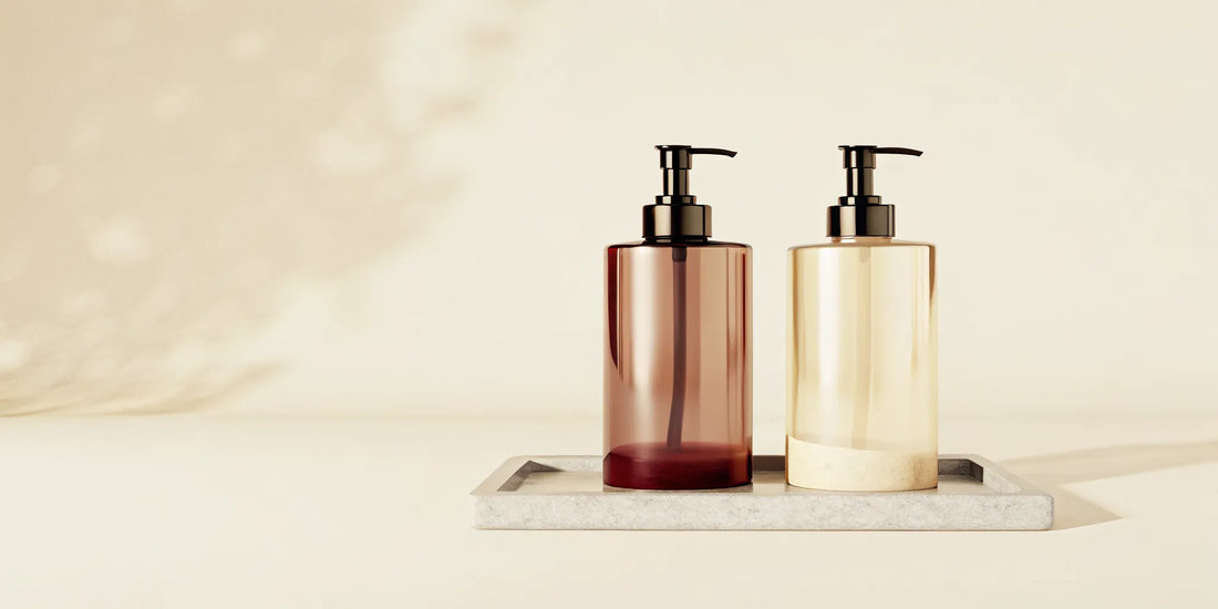 A perfect hand soap duo in amber and cream pump bottles on a minimalist tray.