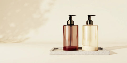 A perfect hand soap duo in amber and cream pump bottles on a minimalist tray.