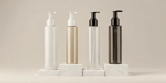 A set of four refillable pump bottles for lotion in stylish, neutral colors.