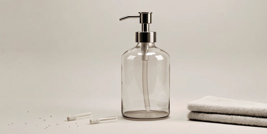 A clear soap pump with its parts laid out, showing how to fix a clogged or broken dispenser.
