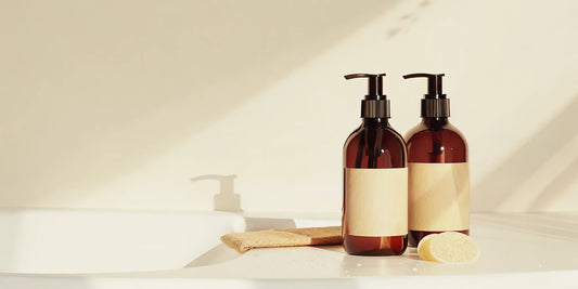 Luxury hand soap refill pouch and reusable dispensers on a modern sink