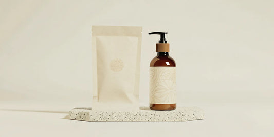 Paraben free hand soap beside a reusable dispenser and refill pouch