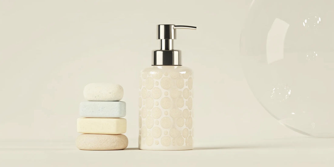 Foaming hand soap refill tablets stacked next to a reusable dispenser.