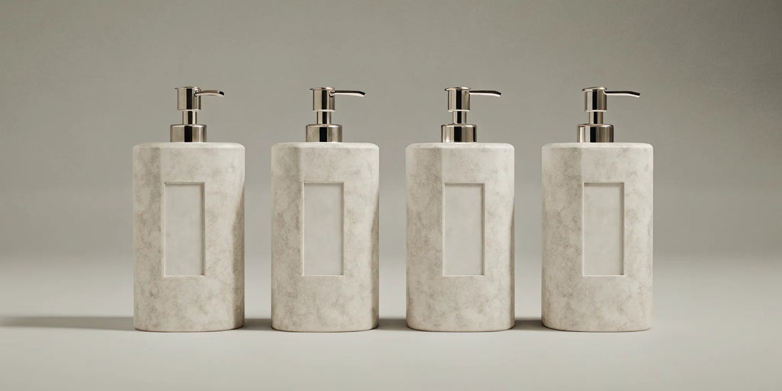 Modern beige soap dispensers with silver pumps for a minimalist kitchen or bathroom.