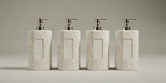Modern beige soap dispensers with silver pumps for a minimalist kitchen or bathroom.