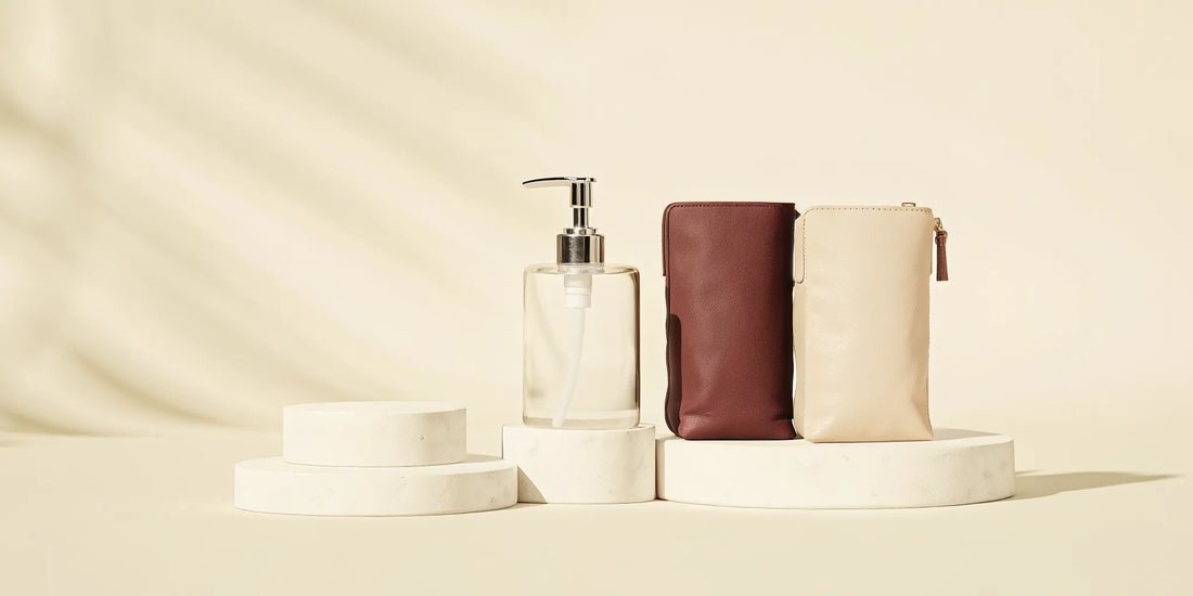 A hand soap refill bag next to a reusable soap dispenser.