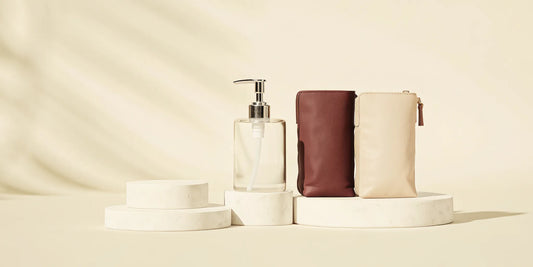 A hand soap refill bag next to a reusable soap dispenser.