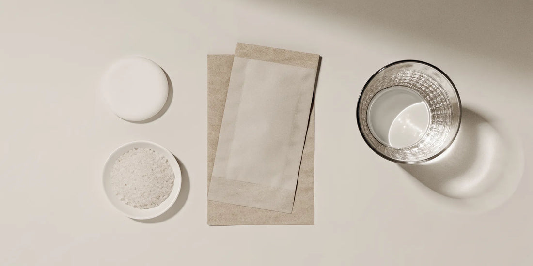 Foaming hand wash refill tablets and a glass of water for making liquid hand soap.