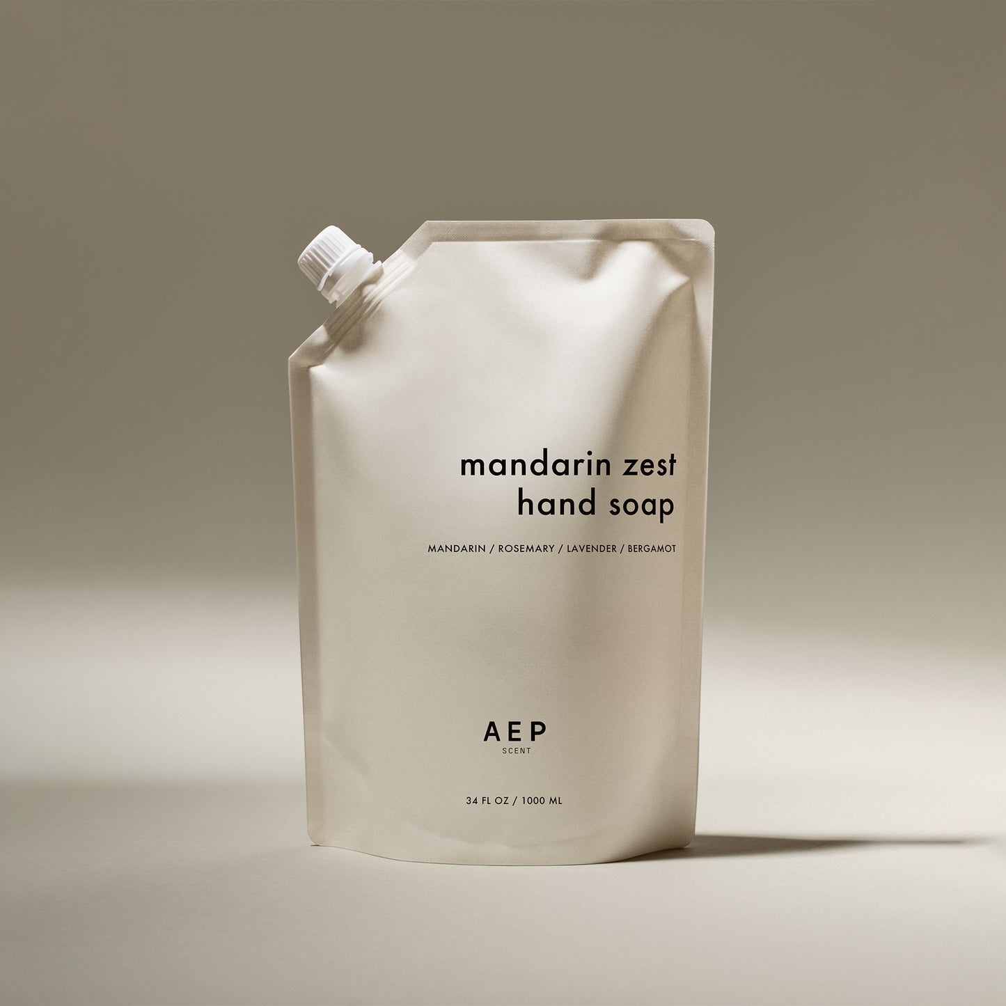 AEP Scent Mandarin Zest hand soap refill pouch in minimalist beige packaging, featuring notes of mandarin, rosemary, lavender, and bergamot, made in California.
