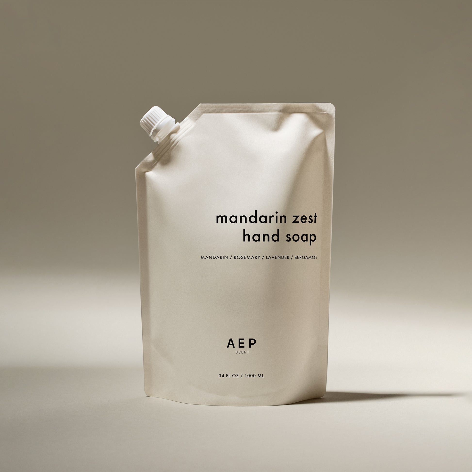 AEP Scent Mandarin Zest hand soap refill pouch in minimalist beige packaging, featuring notes of mandarin, rosemary, lavender, and bergamot, made in California.
