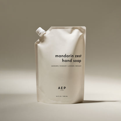 AEP Scent Mandarin Zest hand soap refill pouch in minimalist beige packaging, featuring notes of mandarin, rosemary, lavender, and bergamot, made in California.
