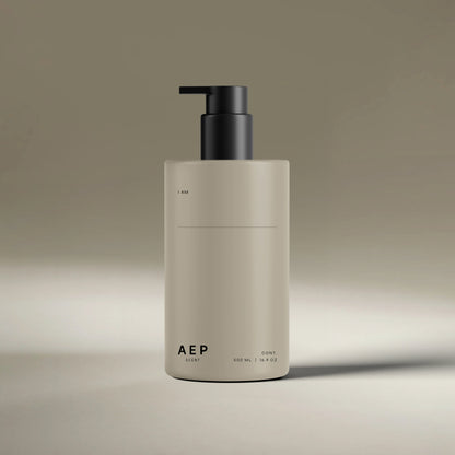 AEP Scent reusable lotion and soap dispenser bottle in matte beige with black pump, minimalist design for premium refill use, photographed on a neutral background.