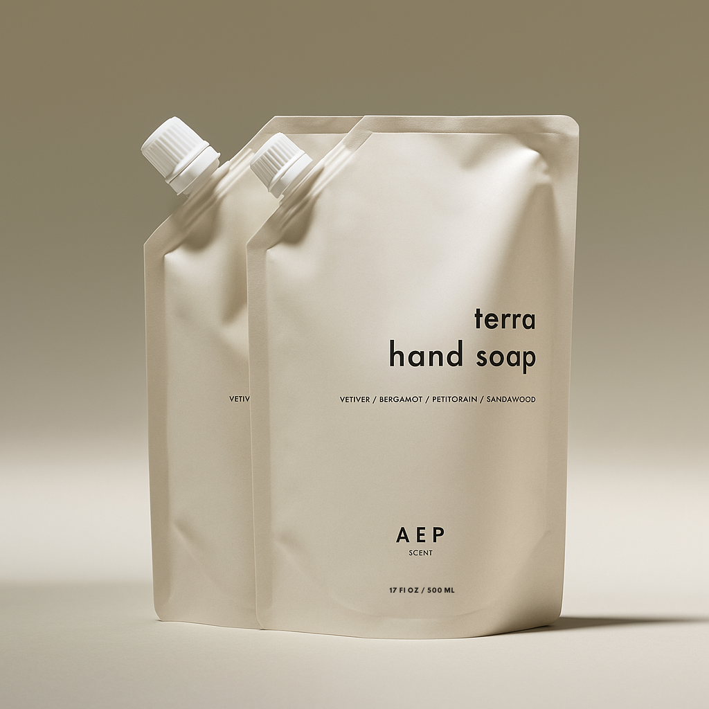 Two AEP Scent Terra hand soap refill pouches on a beige background, featuring notes of vetiver, bergamot, petitgrain, and sandalwood, showcasing the 2-pack value  bundle option.