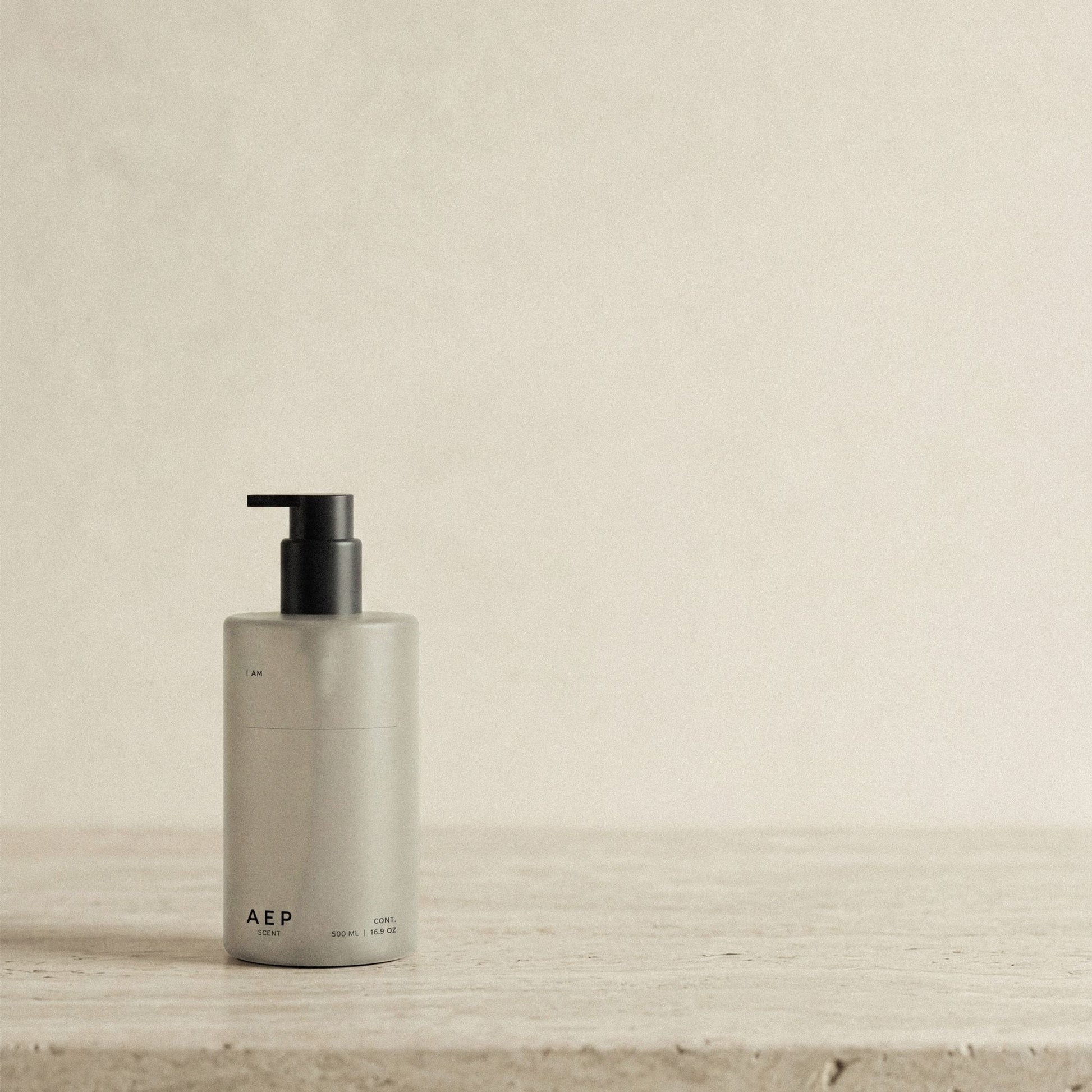 AEP Scent reusable, transluscent soap dispenser bottle in matte beige with black pump, minimalist design for premium refill use, photographed on a neutral background.