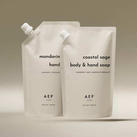 AEP Scent Mandarin Zest hand soap and Coastal Sage body and hand soap refill pouches displayed together on a beige background, showcasing the 2-pack bundle of premium, eco-friendly refills.