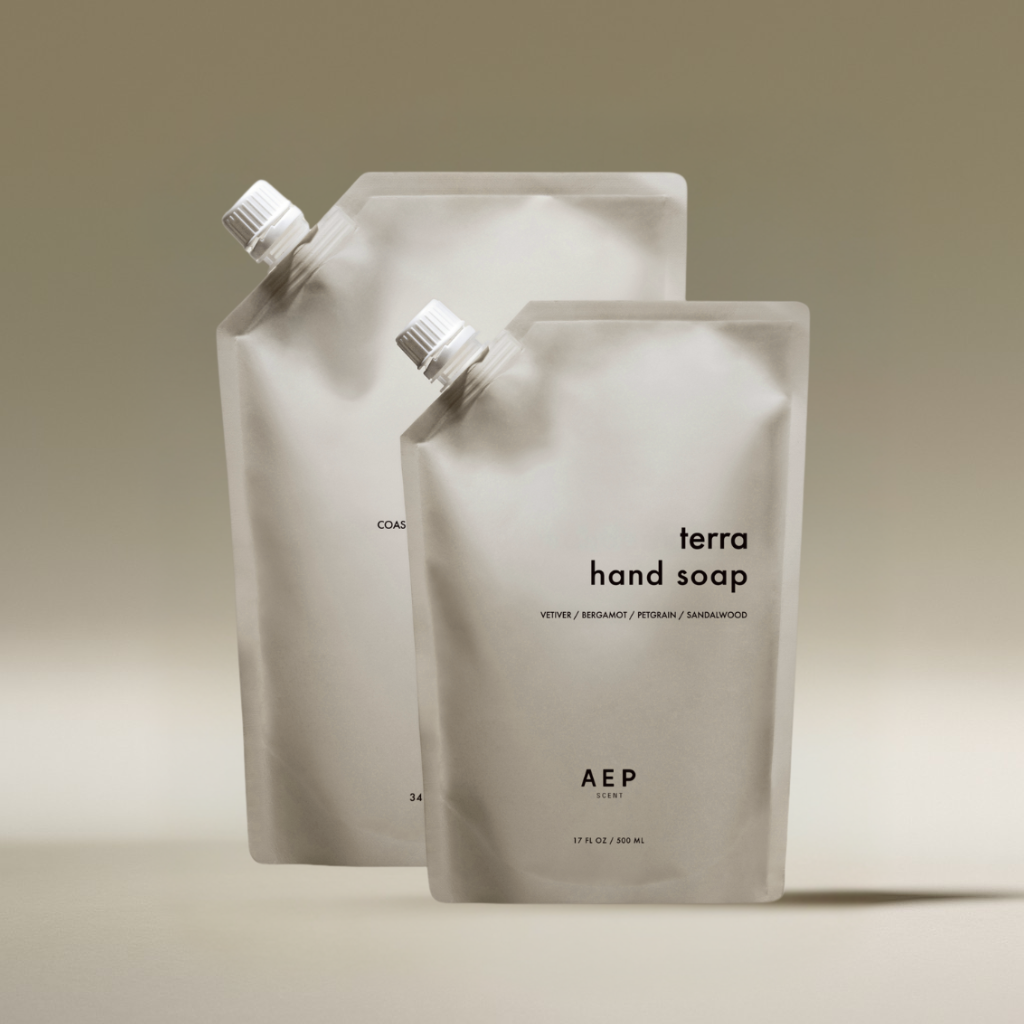 AEP Scent Terra hand soap and Coastal Sage body and hand soap refill pouches displayed together on a beige background, showcasing the 2-pack bundle of premium, eco-friendly refills.