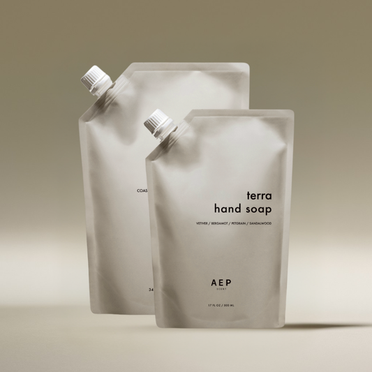 AEP Scent Terra hand soap and Coastal Sage body and hand soap refill pouches displayed together on a beige background, showcasing the 2-pack bundle of premium, eco-friendly refills.