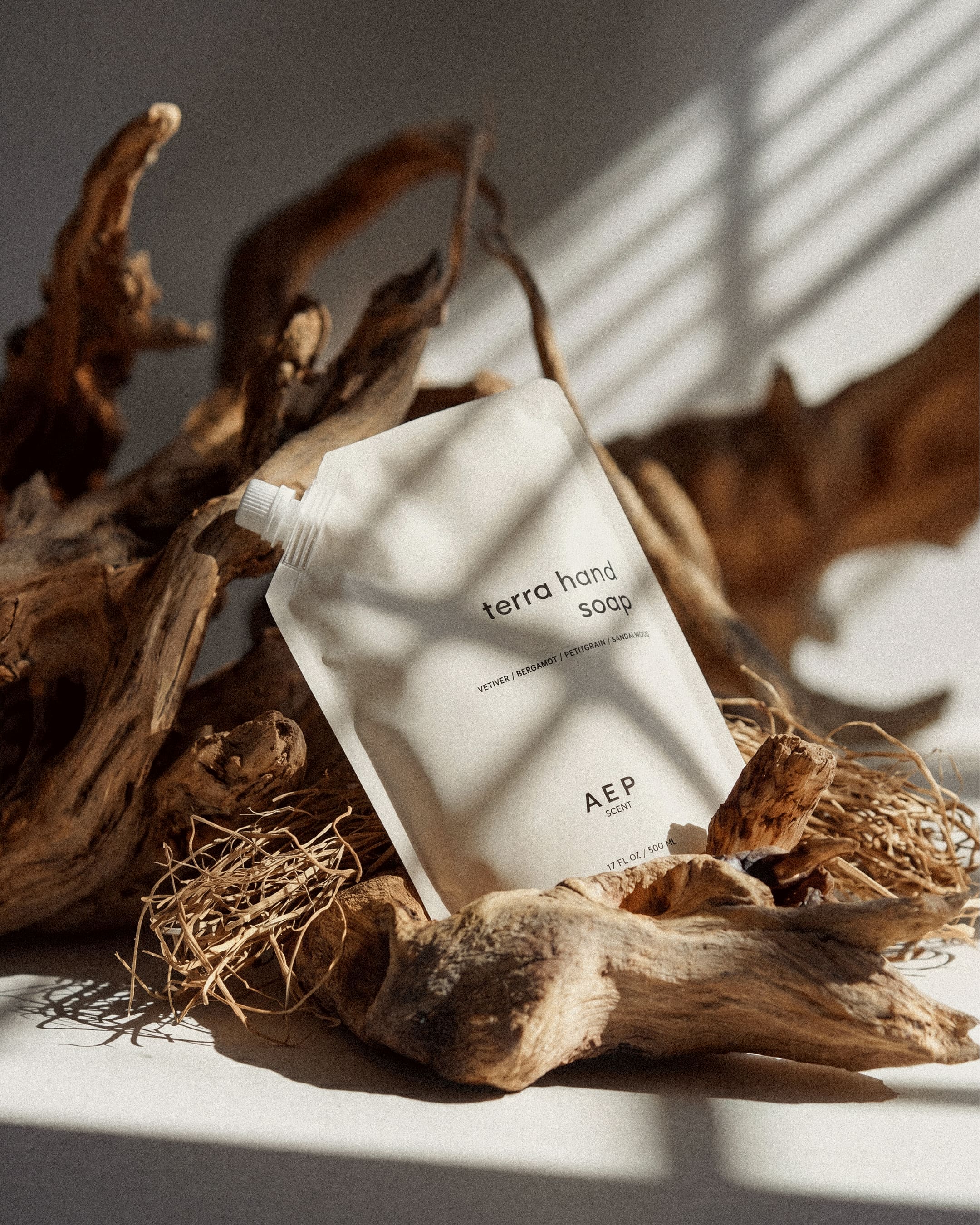 Terra hand soap packaging on a natural wood background